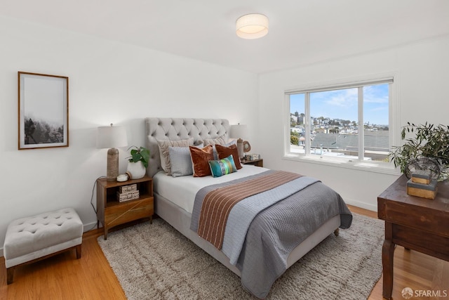 bedroom featuring baseboards and light wood-type flooring