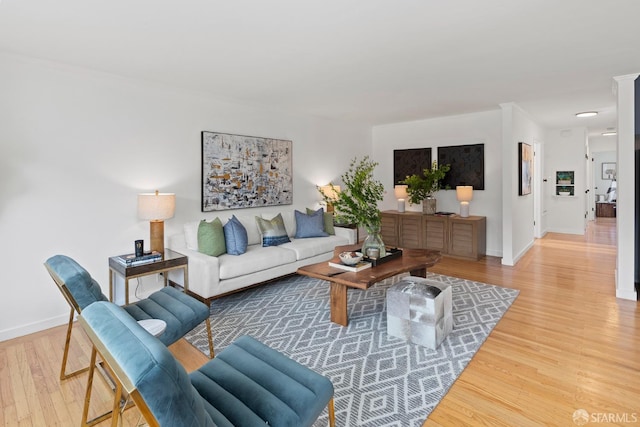 living area with wood finished floors and baseboards