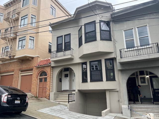 view of front facade with stucco siding and an attached garage