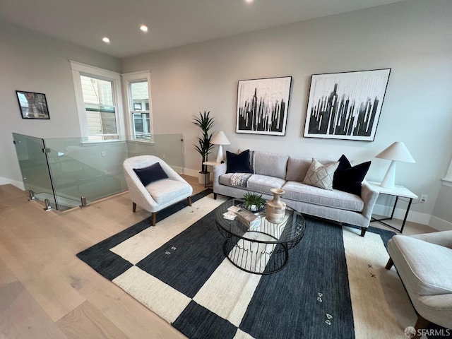 living room with recessed lighting, baseboards, and wood finished floors