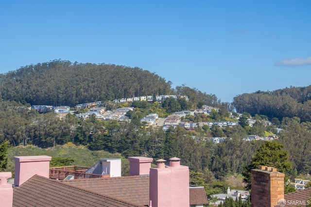 drone / aerial view featuring a wooded view