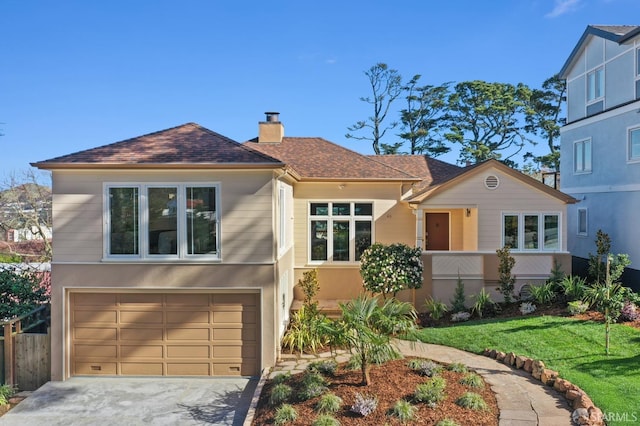 view of front facade with a garage, concrete driveway, a chimney, and stucco siding