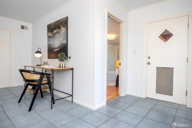 office space with baseboards, visible vents, and crown molding