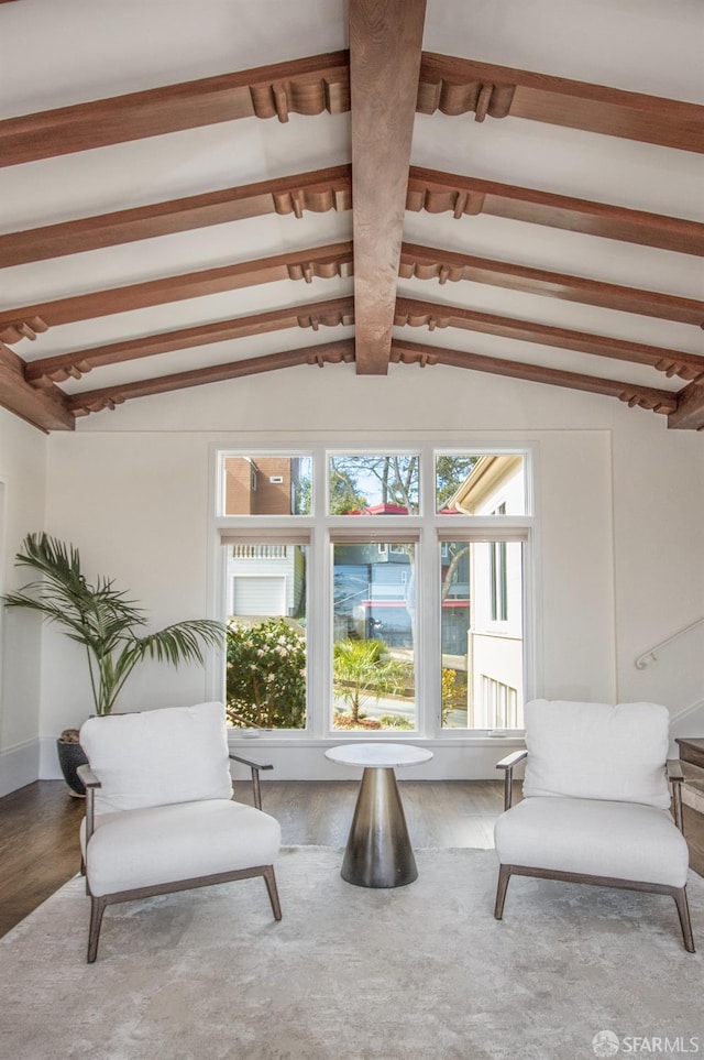 sitting room featuring vaulted ceiling with beams and wood finished floors