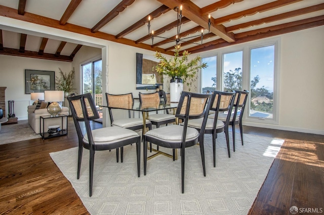 dining space featuring wood finished floors, beam ceiling, and baseboards