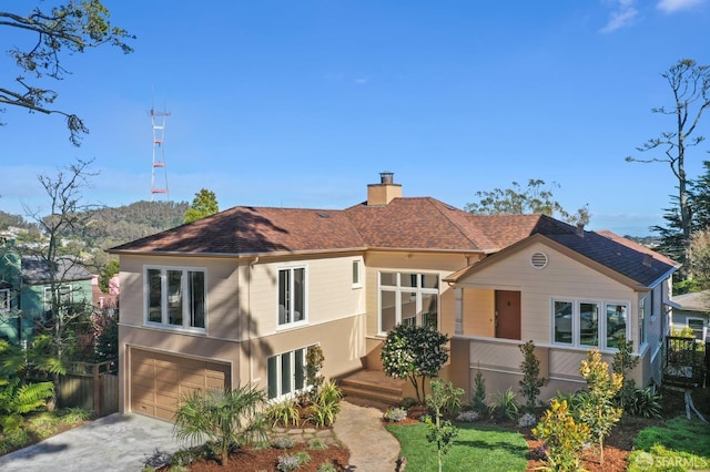 view of front of property featuring an attached garage, fence, driveway, roof with shingles, and a chimney