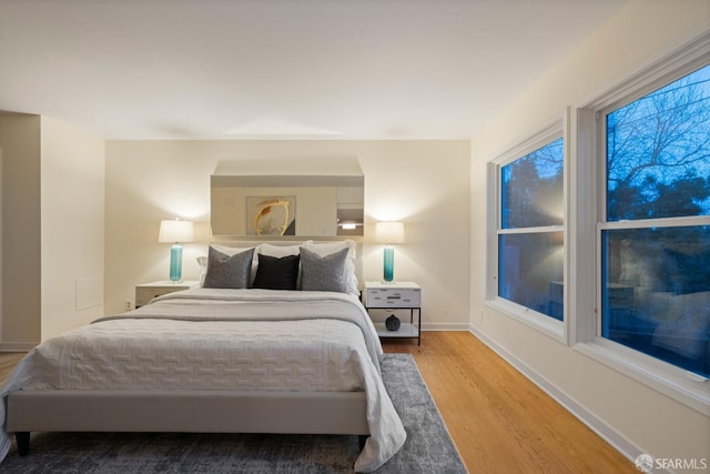 bedroom featuring baseboards and wood finished floors