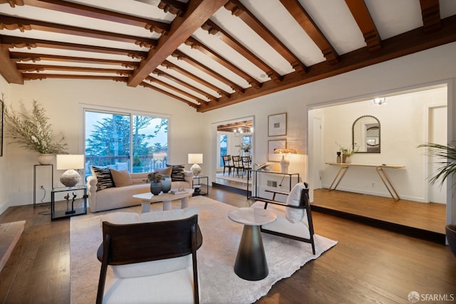 living area featuring vaulted ceiling with beams, wood finished floors, and baseboards