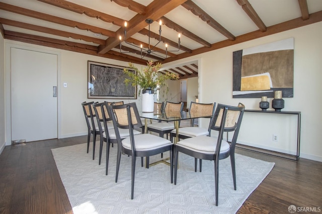 dining space featuring an inviting chandelier, beam ceiling, baseboards, and wood finished floors