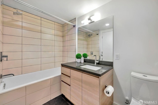 full bathroom with tiled shower / bath combo, vanity, and toilet