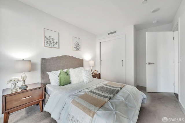 carpeted bedroom with a closet