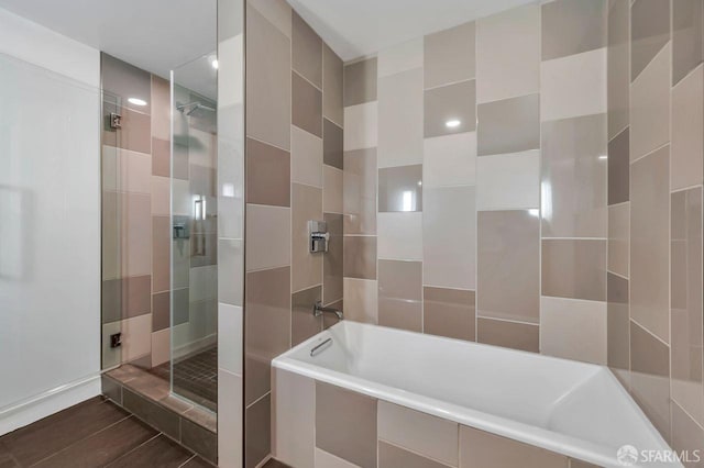 bathroom with shower with separate bathtub