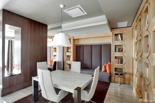 dining room featuring wooden walls