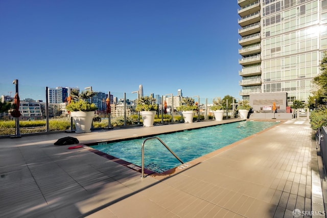 view of swimming pool featuring a patio area