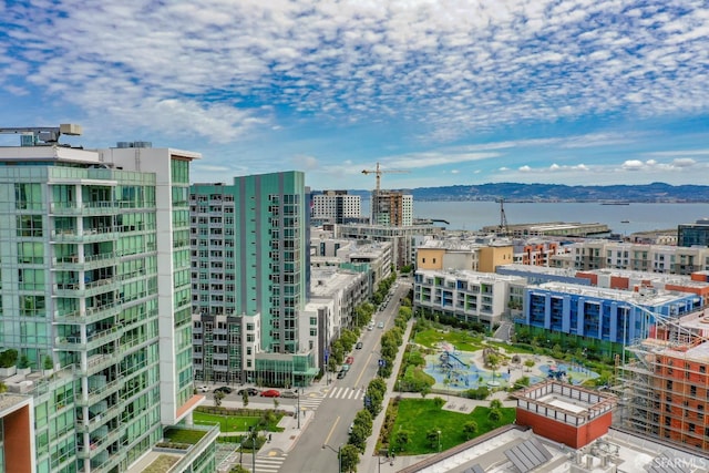 property's view of city with a water and mountain view