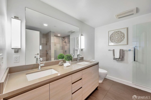 bathroom with an enclosed shower, vanity, tile patterned flooring, and toilet