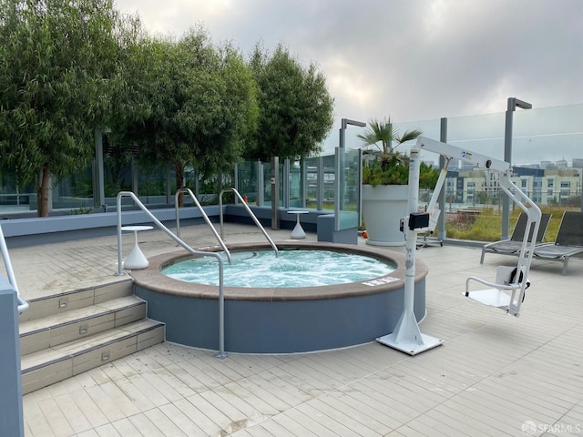 view of swimming pool with a community hot tub