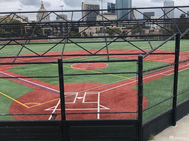 view of sport court featuring fence