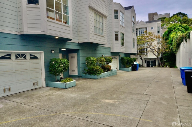 exterior space with a garage and concrete driveway