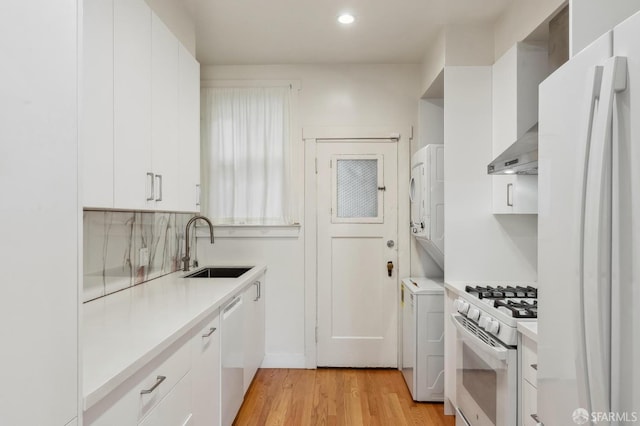 kitchen with light countertops, white appliances, and white cabinets