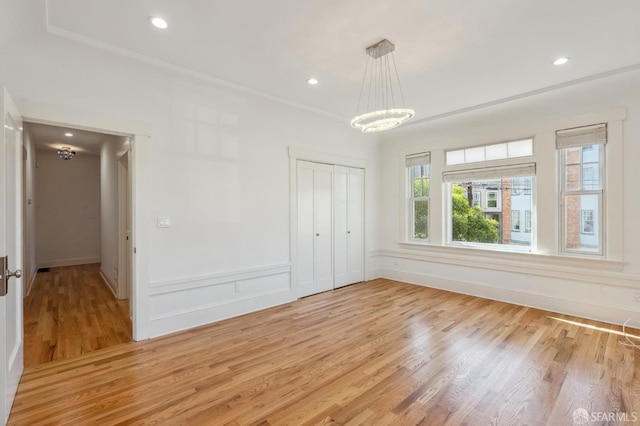 interior space with crown molding, a chandelier, light wood-style flooring, and recessed lighting