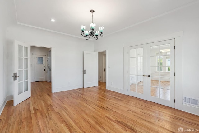 interior space with ornamental molding, french doors, light wood-style flooring, and visible vents