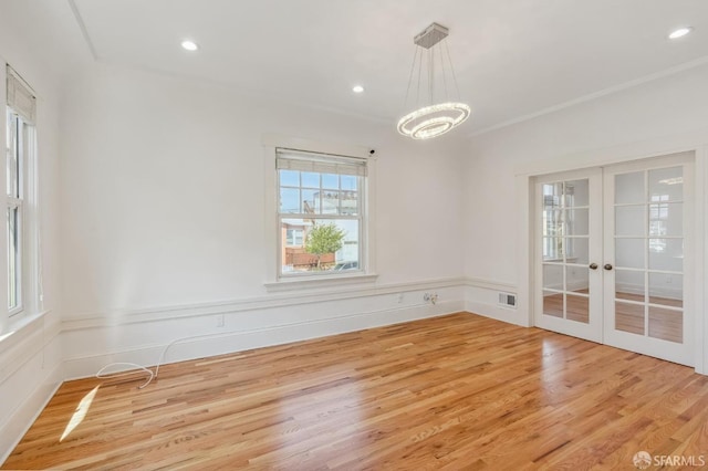 spare room with light wood-style floors, recessed lighting, french doors, and visible vents