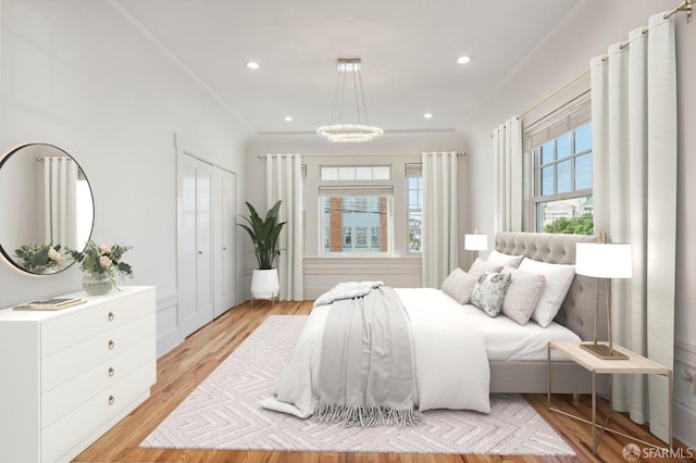 bedroom featuring crown molding, light wood finished floors, and recessed lighting