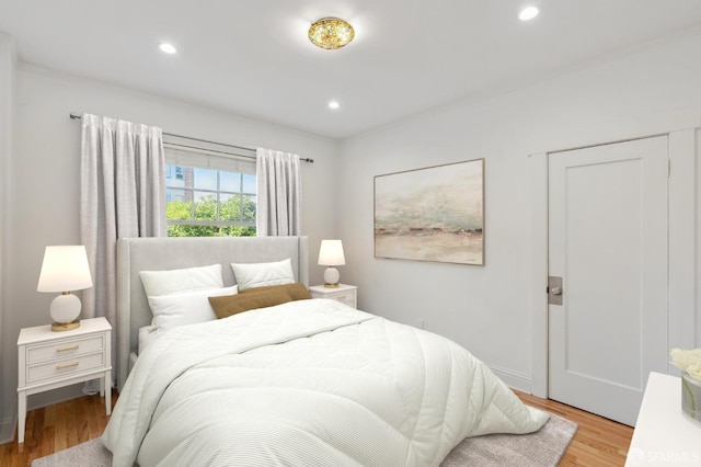 bedroom featuring light wood-style flooring and recessed lighting