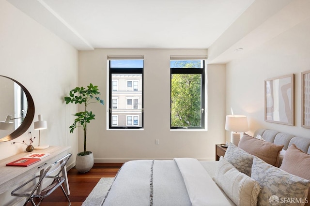 bedroom with dark hardwood / wood-style flooring