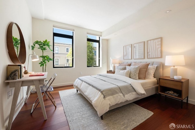 bedroom with dark hardwood / wood-style floors