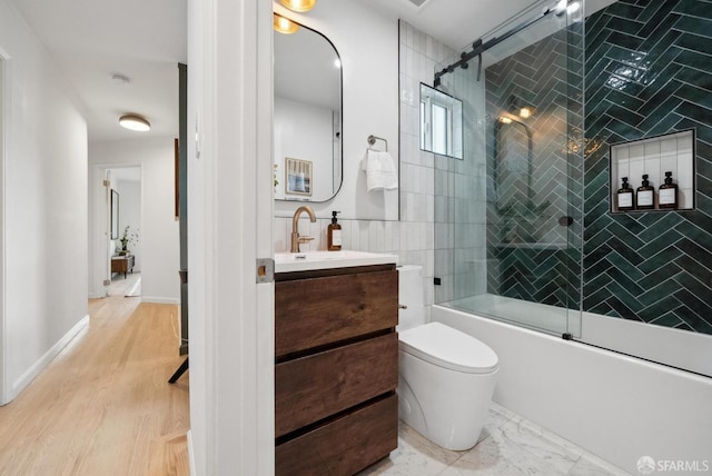 full bathroom with vanity, toilet, marble finish floor, and bath / shower combo with glass door