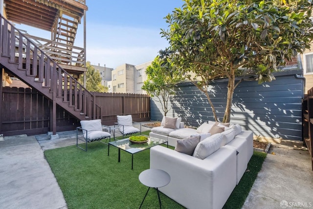 view of patio with stairway, outdoor lounge area, and a fenced backyard