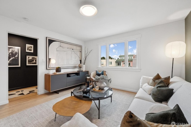 living area featuring light wood-style floors and baseboards