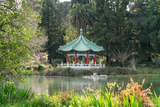 view of community with a forest view and a water view