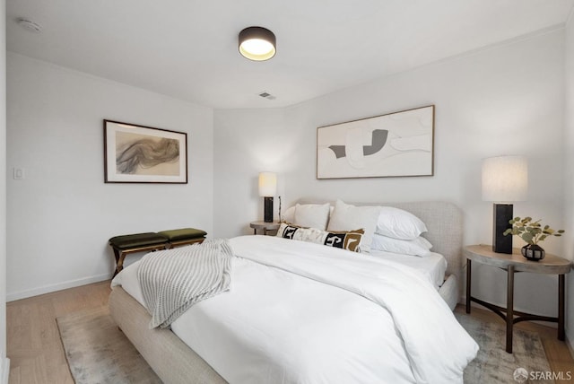 bedroom with visible vents, baseboards, and light wood-style floors