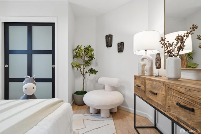 bedroom featuring wood finished floors and baseboards