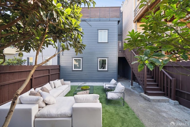 back of house with stairs, a patio, fence, and an outdoor hangout area