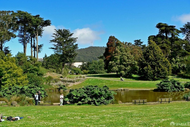 surrounding community featuring a lawn and a water and mountain view