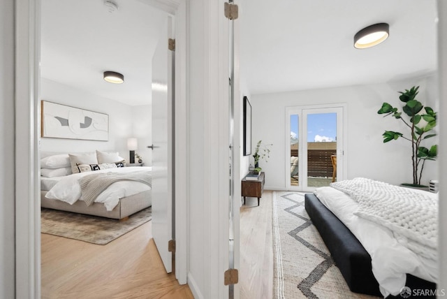 bedroom with light wood-type flooring and access to outside