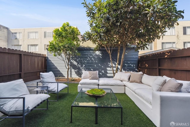 view of patio / terrace with an outdoor living space and a fenced backyard