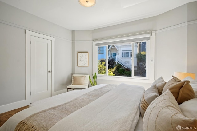 bedroom with wood finished floors and baseboards