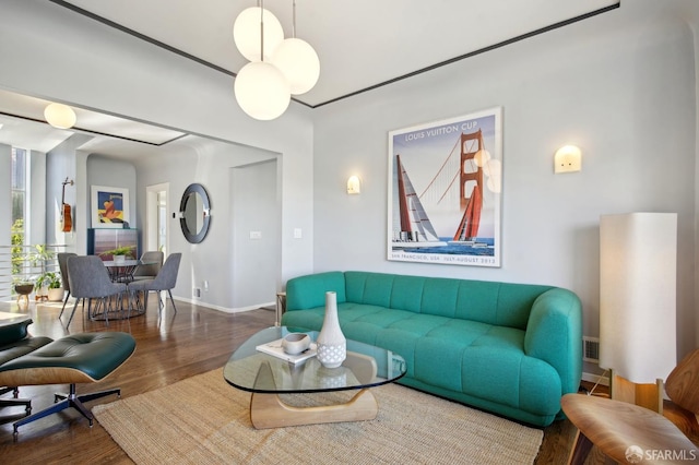 living area with wood finished floors and baseboards
