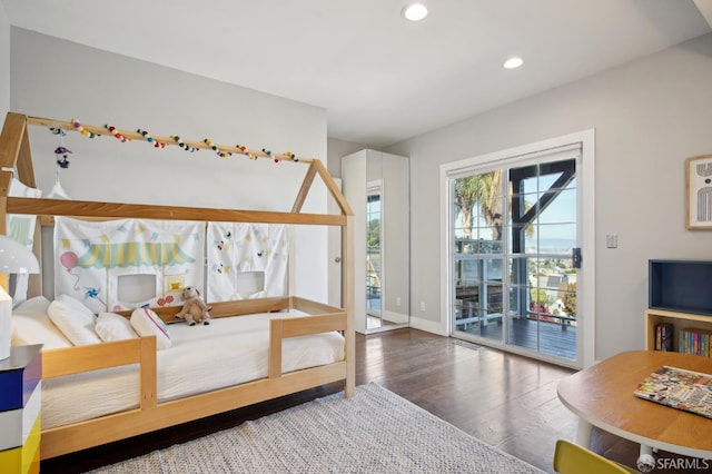 bedroom featuring access to exterior, wood finished floors, recessed lighting, and baseboards