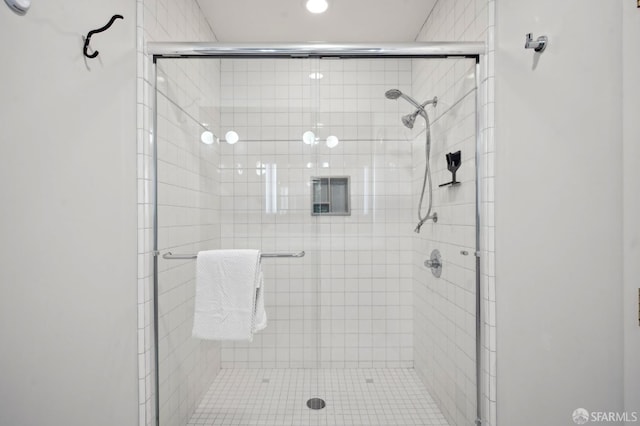 bathroom with a shower stall and recessed lighting
