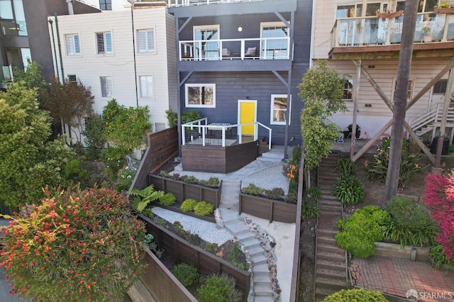 rear view of house featuring stairs
