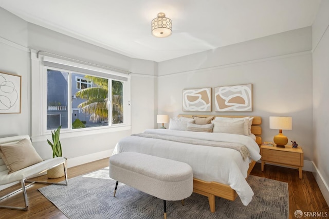 bedroom featuring baseboards and wood finished floors