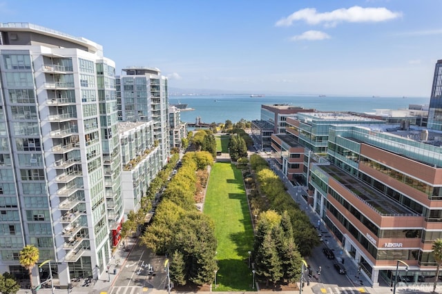 birds eye view of property with a water view and a view of city