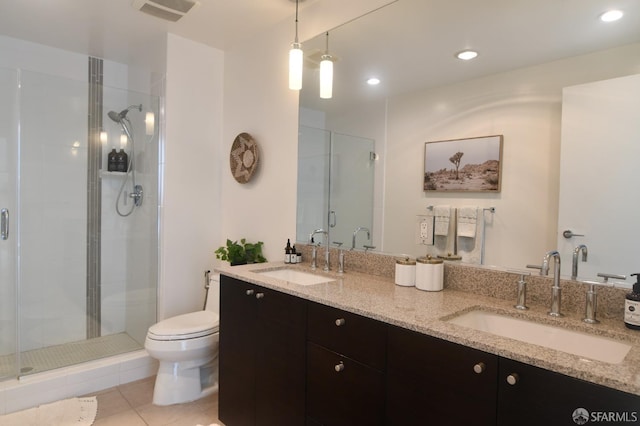 bathroom with a stall shower, visible vents, a sink, and toilet