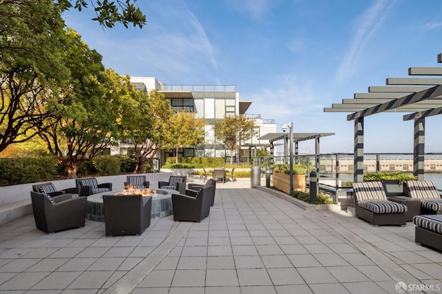 view of patio / terrace featuring an outdoor living space with a fire pit and a pergola